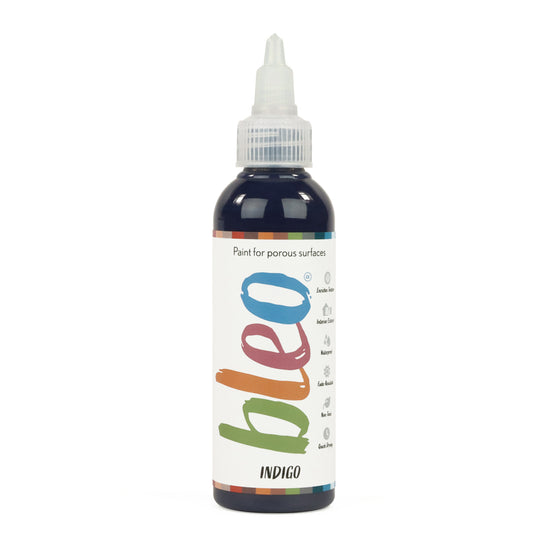 A bottle containing coloured gel paint, on a white background of bleo indigo
