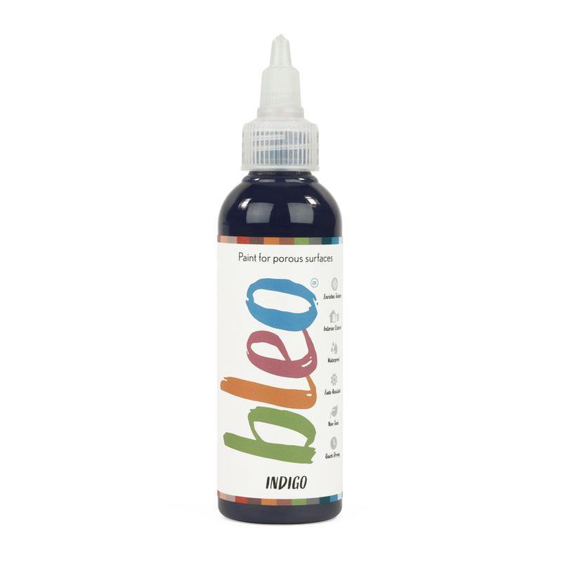A bottle containing coloured gel paint, on a white background of bleo indigo