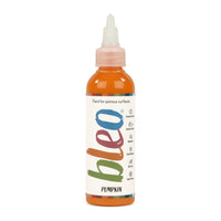 A bottle containing coloured gel paint, on a white background of bleo pumpkin