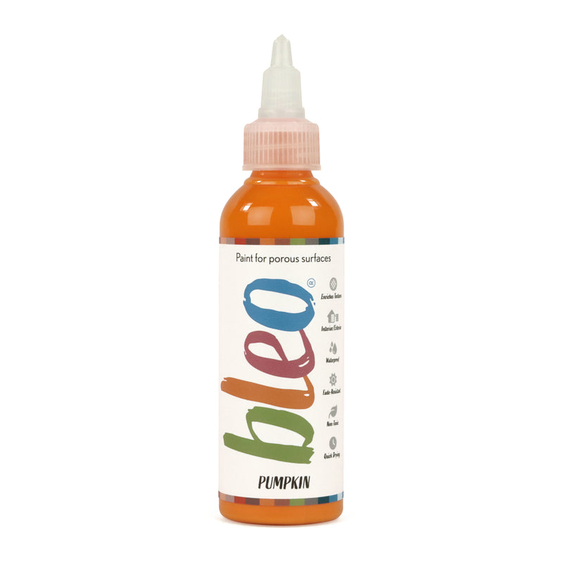 A bottle containing coloured gel paint, on a white background of bleo pumpkin