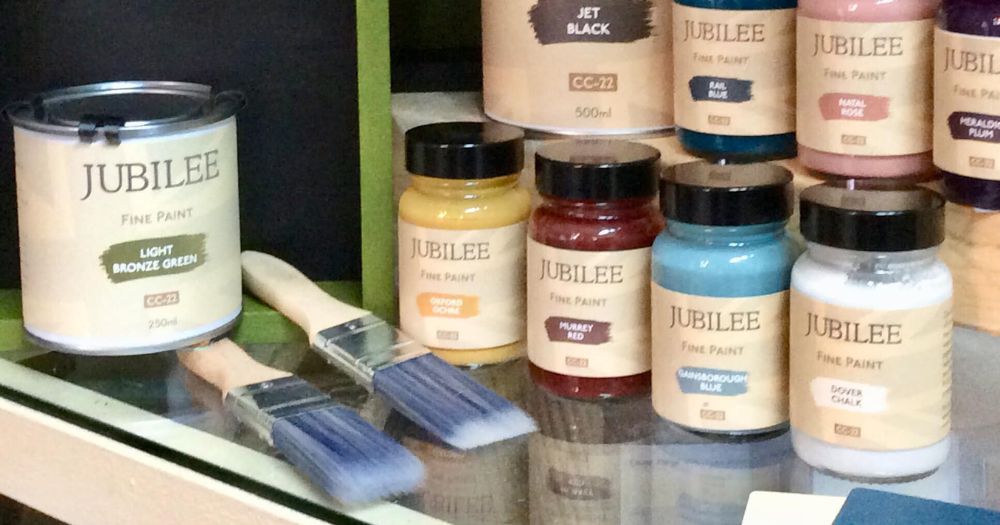 Jubilee paint jars in a selection of colours lined up