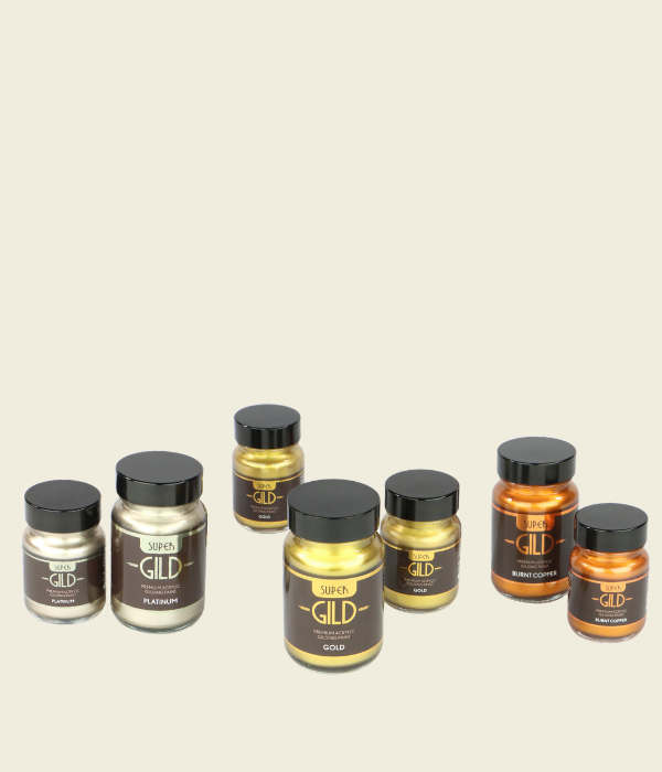 Set of Super GILD paint jars on a beige background