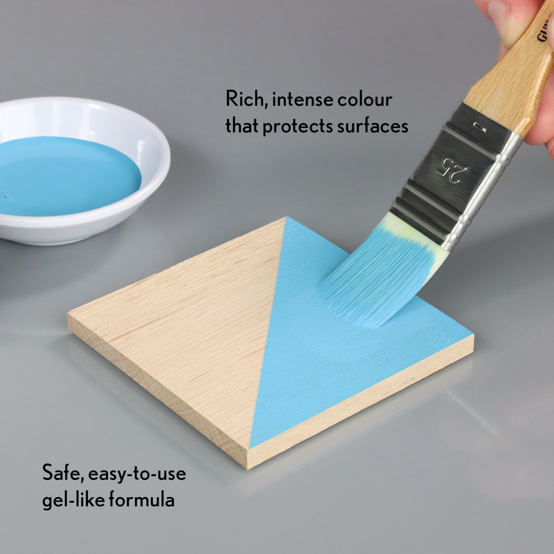 Blue paint being applied to a wooden triangle with text about the paint's properties.