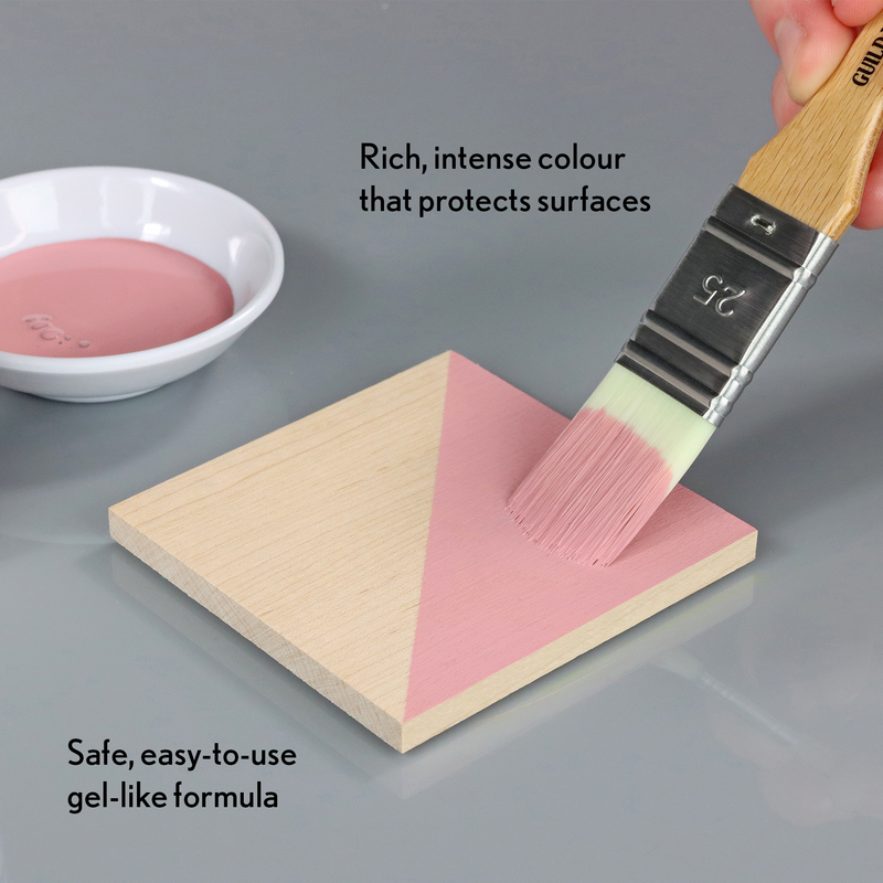 Pink gel-like substance being applied with a brush to a wooden block, with text describing its properties.