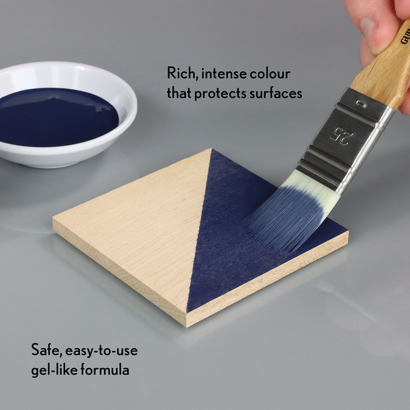 Indigo finish paint being applied to a wooden surface with text describing its properties.