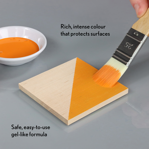 
                      
                        Orange paint being applied to a wooden triangle with a brush, next to a bowl of paint and text describing the product.
                      
                    