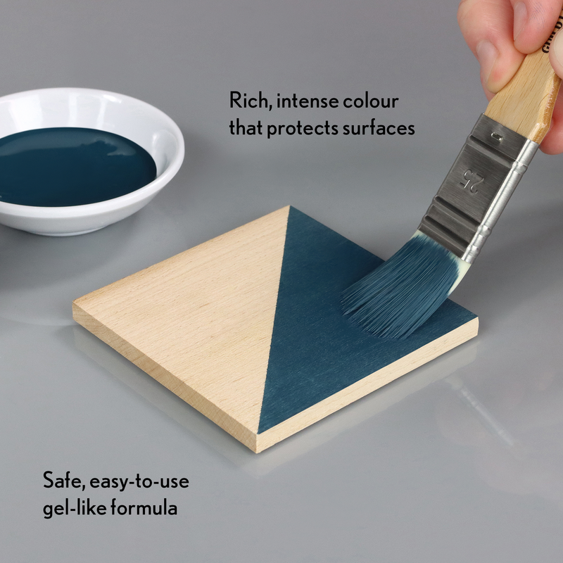 Paintbrush applying blue paint to a wooden triangle with text about the product's features.
