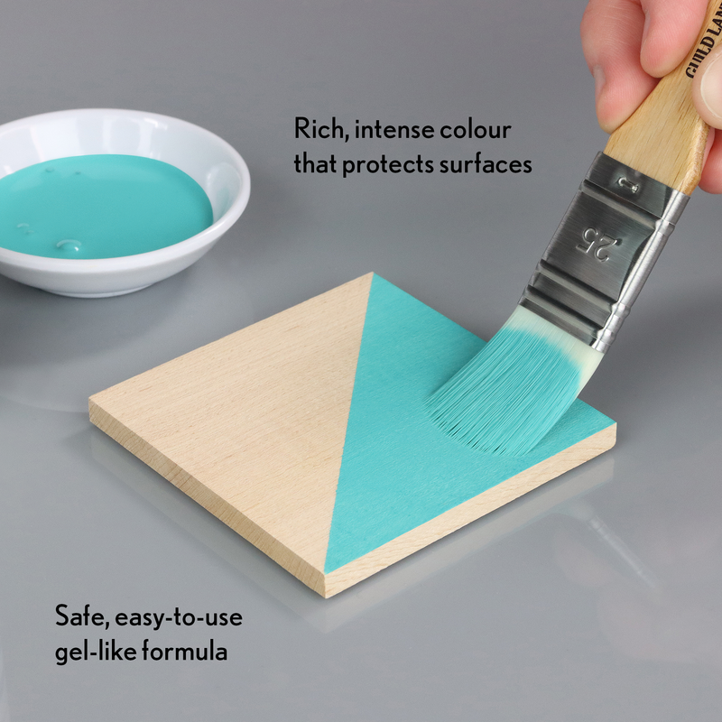 Teal paint being applied to a wooden surface with text describing its properties.