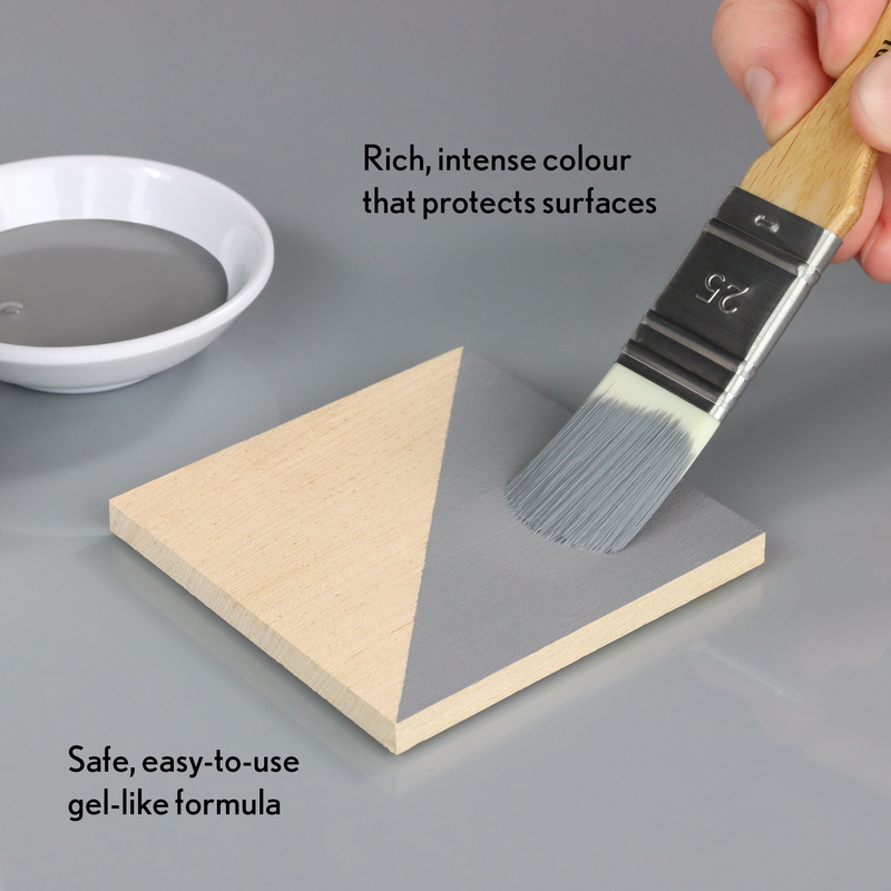 Person applying grey gel-like substance to a wooden block with a brush, text highlighting features.