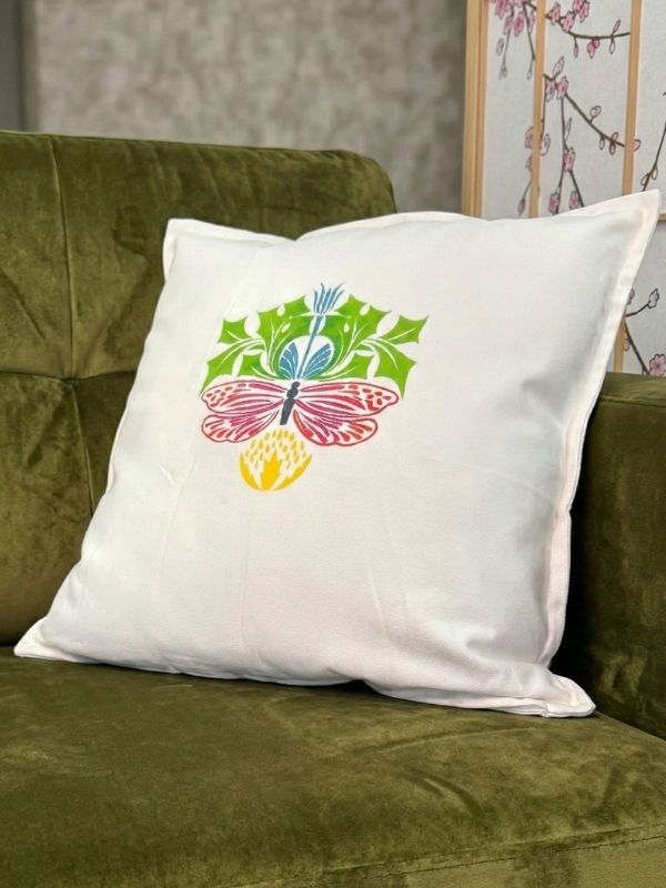 Decorative pillow with a colorful butterfly design on a couch