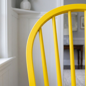 
                      
                        Close up of back slats painted on a bright yellow chair
                      
                    