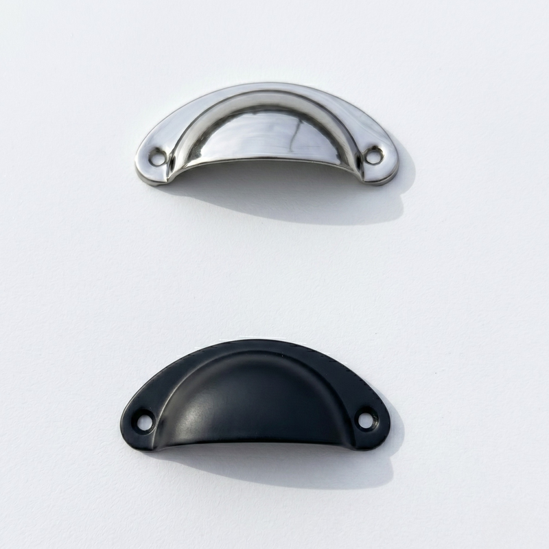 Two metallic cabinet handles, one metallic chrome mirror silver and one black, on a white background.