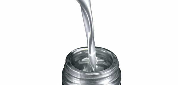 Metallic silver paint pouring into glass jars