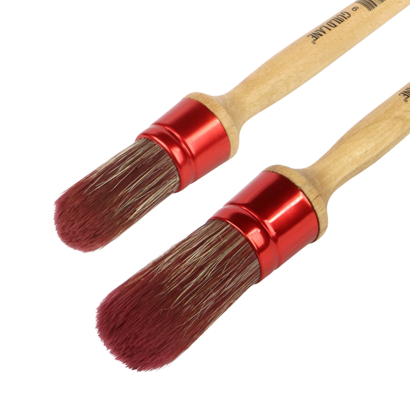 Two wooden brushes with red ferrules on a white background