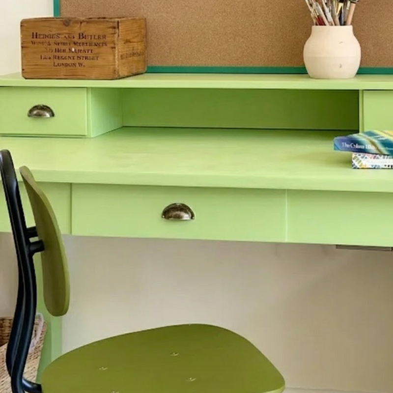 Eau de nil painted green desk with supplies on