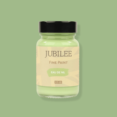 Jar of Jubilee fine paint on a green background