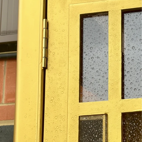 An outdoor door frame gilded with Super GILD, beaded with rain