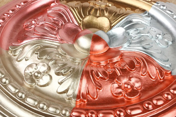 Decorative crown moulding with gold, silver, and rose colours featuring intricate patterns.