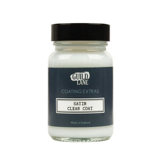 A jar of Guild Lane Satin Clear Coat, a coating extras product, with the label indicating it is made in England.
