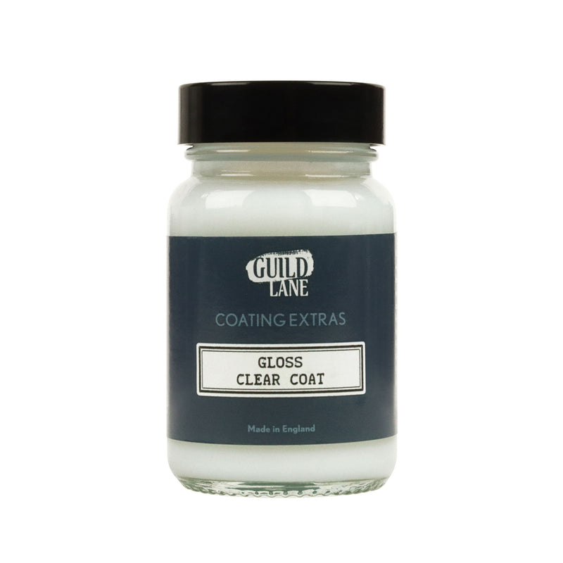 A bottle of Guild Lane gloss top coat with the label clear coat indicated as gloss finish for coating extras, made in England.