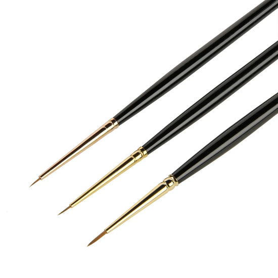Three paintbrushes with black handles and gold ferrules on a white background