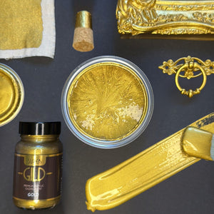 
                      
                        Super GILD Gold metallic painted items and materials on a dark surface
                      
                    