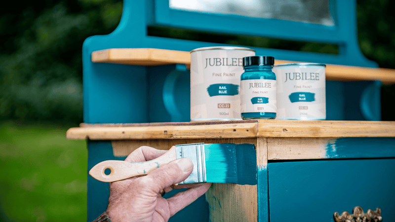 Jubilee rail blue furniture paint being painted on a cabinet, for indoors and outdoors