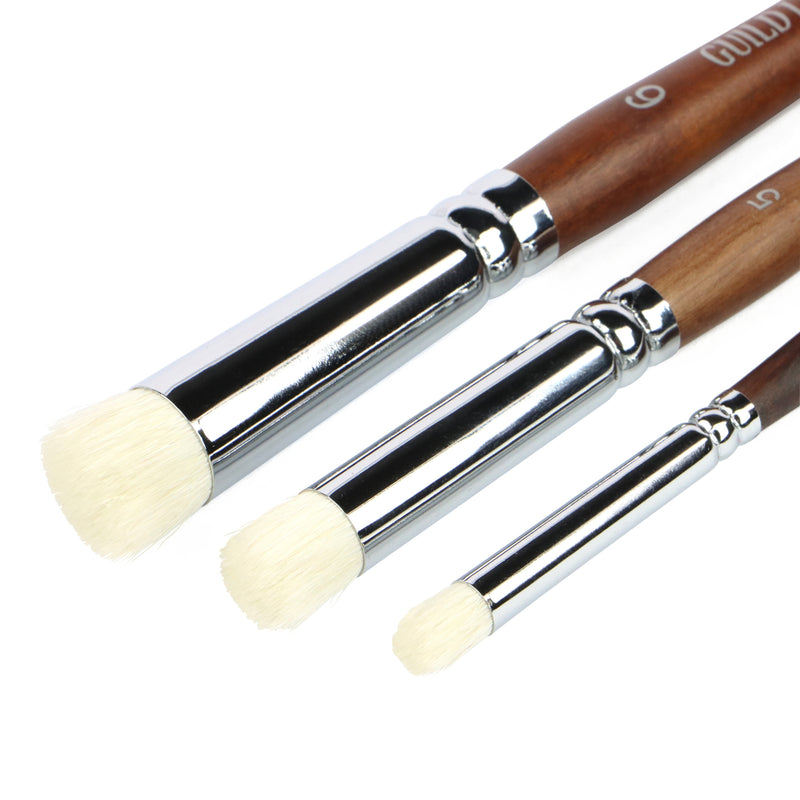 Three dry brush brushes with wooden handles and white bristle heads on a white background