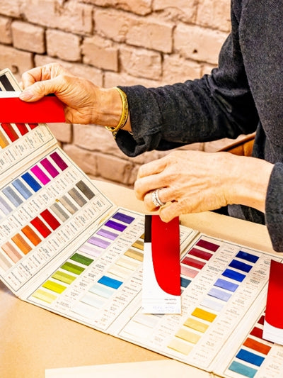 Jeni holding colour swatches on cards