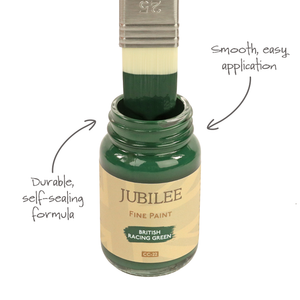 
                      
                        Jubilee Fine Paint jar with a brush dipping into green paint, labeled 'Durable, self-scaling formula' and 'Smooth, easy application'.
                      
                    