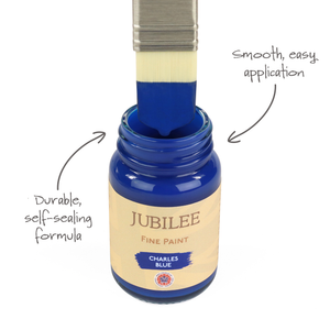 
                      
                        Blue paint being applied with a brush to a bottle labeled 'Jubilee Fine Paint' on a white background.
                      
                    