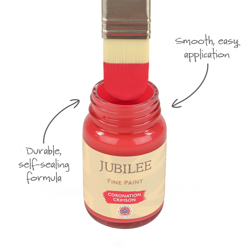 Bottle of Jubilee Fine Paint with a brush loaded with red paint, labeled 'Coronation Crimson'.