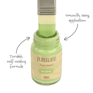 
                      
                        Bottle of Jubilee Fine Paint with a brush applying paint, labeled for smooth application and durable formula.
                      
                    