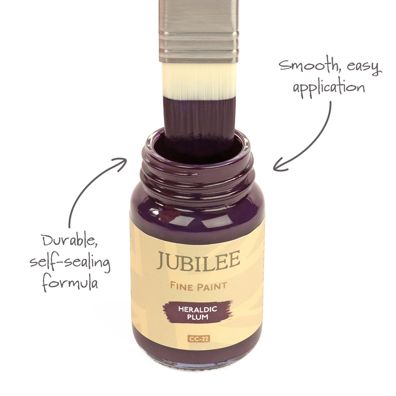 Bottle of Jubilee Fine Paint with a brush applying paint, labeled 'Heraldic Plum'.