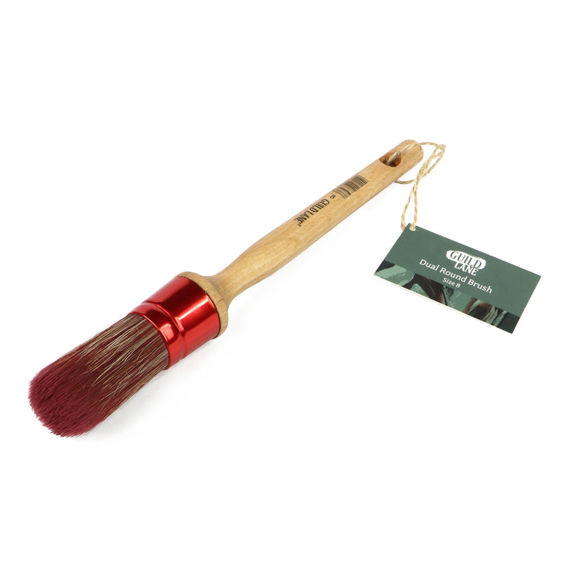 Dual-ended brush with red bristle brush and wooden handle on a white background