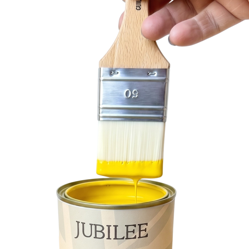 Can of Jubilee fine paint with a brush dipping into yellow paint