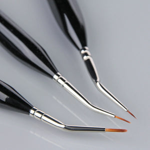 
                      
                        Set of three paintbrushes with black handles and silver ferrules on a gray background
                      
                    