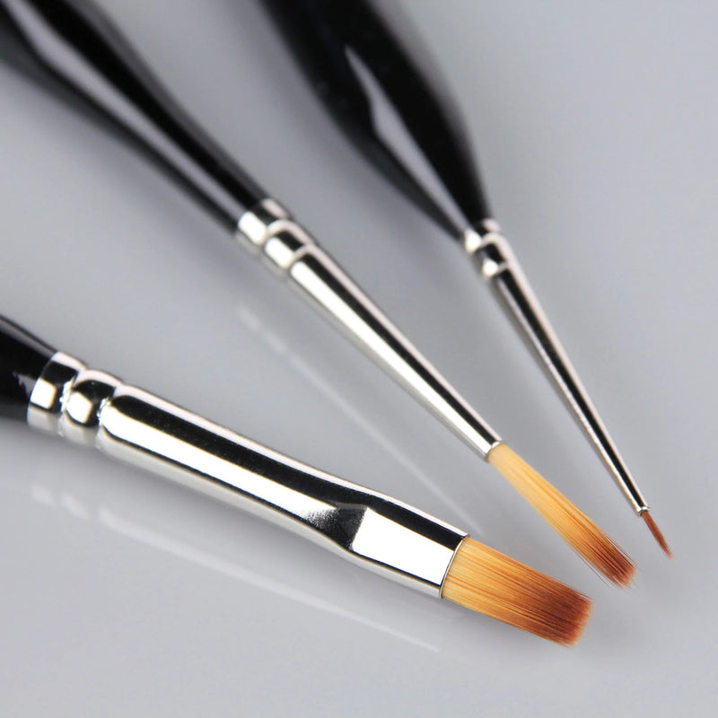 Three paintbrushes with black handles and silver ferrules on a gray background