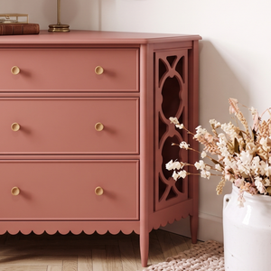 
                      
                        A piece of furniture painted in a dusky pink paint colour with dried flowers next to it
                      
                    