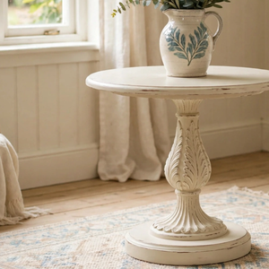 
                      
                        Small Old English White side table with ornate carvings and a ceramic jug on top
                      
                    