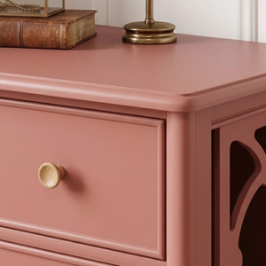 
                      
                        A close up of the corner of a piece of furniture painted in dusky pink paint
                      
                    