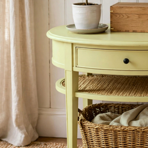 
                      
                        The edge of a small side table painted in pale primrose paint
                      
                    