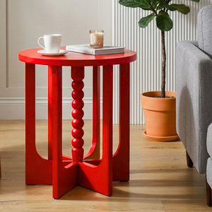 
                      
                        A bright red side table in a lounge setting
                      
                    