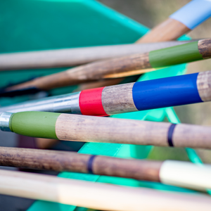 
                      
                        Colourful spade handles with wooden handles and colourful grips on a blurred green background
                      
                    