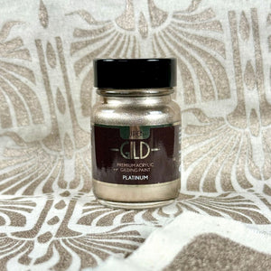 
                      
                        Jar of premium acrylic gilding paint on a textured surface
                      
                    