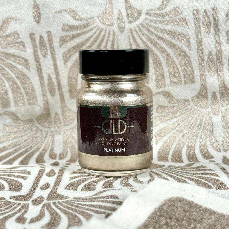 Jar of premium acrylic gilding paint on a textured surface