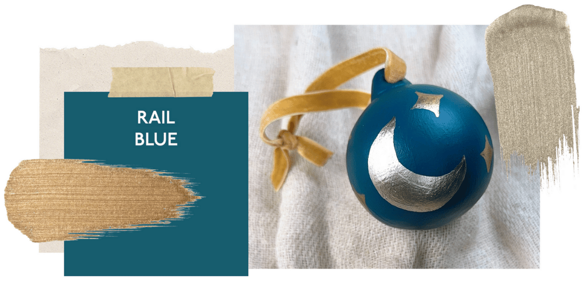 Blue bauble with a gold paint swipe handle on a textured white background, next to a swatch labelled 'Rail Blue'.