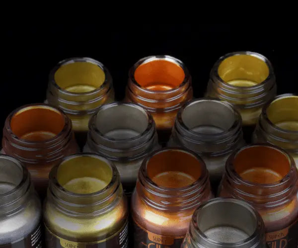 Collection of metallic paint jars in various colors on a black background