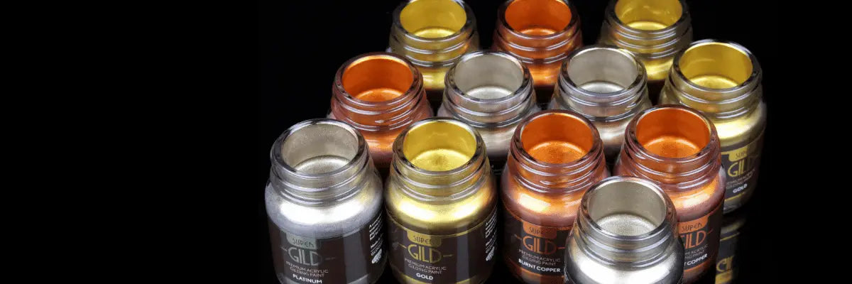 Collection of paint jars with metallic finishes on a black background