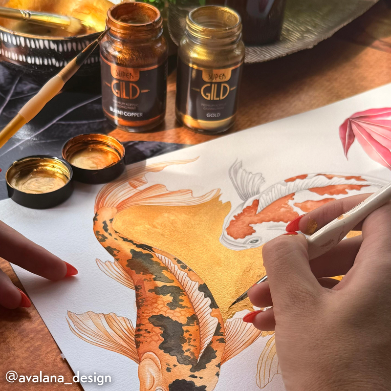Person using a brush to apply gold paint to a Koi fish illustration on paper, with GILD coffee jars in the background.